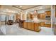 Open-concept kitchen with wood cabinets, granite countertops, stainless steel appliances, and island at 6120 Kings Brook Ct, Las Vegas, NV 89149