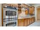 Modern kitchen featuring stainless steel appliances, ample cabinet space, and tile backsplash at 6120 Kings Brook Ct, Las Vegas, NV 89149