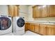 Laundry room featuring front load washer and dryer, ample cabinet space, and a utility sink at 6120 Kings Brook Ct, Las Vegas, NV 89149