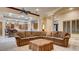 Inviting living room open to kitchen, featuring large sectional sofa and stone pillars at 6120 Kings Brook Ct, Las Vegas, NV 89149