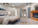 Staged main bedroom featuring a fireplace, ensuite bathroom, and ample natural light at 6120 Kings Brook Ct, Las Vegas, NV 89149