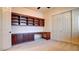 Bedroom featuring a custom wood desk with storage and shelving, plus double closet at 6120 Kings Brook Ct, Las Vegas, NV 89149