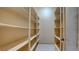 Spacious walk-in pantry with abundant shelving on both sides and tile flooring at 6120 Kings Brook Ct, Las Vegas, NV 89149