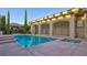 Sparkling pool and spa with an outdoor structure and manicured landscaping offer privacy and shade at 6120 Kings Brook Ct, Las Vegas, NV 89149