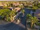 Aerial view of a charming residential street with lush palm trees and well-maintained landscaping at 6120 Kings Brook Ct, Las Vegas, NV 89149