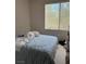 A basic bedroom featuring a window and a bed in neutral tones at 656 Peachy Canyon Cir # 203, Las Vegas, NV 89144