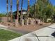 Landscaped community entrance with palm trees and stone features at 656 Peachy Canyon Cir # 203, Las Vegas, NV 89144