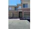 Inviting townhome exterior with a private garage and stone accents around the front door at 656 Peachy Canyon Cir # 203, Las Vegas, NV 89144
