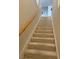 Carpeted staircase with wooden handrail provides access to the upper level at 656 Peachy Canyon Cir # 203, Las Vegas, NV 89144