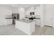 Bright kitchen featuring white cabinets, stainless steel appliances, and a functional center island at 6737 Violet Cascade Ave, Las Vegas, NV 89156