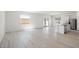 Bright, open-concept living space with wood flooring, flowing into the adjacent kitchen at 6737 Violet Cascade Ave, Las Vegas, NV 89156