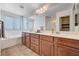 Double vanity bathroom with soaking tub and tiled floors at 7704 Lots Hills Dr, Las Vegas, NV 89179