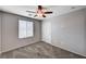 This bedroom features neutral paint, carpet, a window, and a closet at 7704 Lots Hills Dr, Las Vegas, NV 89179
