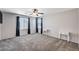 Spacious bedroom features neutral decor, carpeted floors, ceiling fan and ample natural light at 7704 Lots Hills Dr, Las Vegas, NV 89179