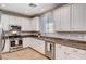 Bright kitchen featuring stainless steel appliances, granite countertops, and ample cabinet space at 7704 Lots Hills Dr, Las Vegas, NV 89179