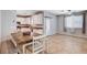 Bright living space featuring tile floors, dining area, and views into an adjacent kitchen at 7704 Lots Hills Dr, Las Vegas, NV 89179
