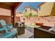 This patio has wicker seating and blue chairs to enjoy the outdoor weather at 7704 Lots Hills Dr, Las Vegas, NV 89179