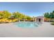 Community pool surrounded by trees and lounge chairs. Perfect for relaxation and recreation at 7704 Lots Hills Dr, Las Vegas, NV 89179