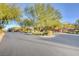 Landscaped residential street with well-maintained homes and lush greenery at 7704 Lots Hills Dr, Las Vegas, NV 89179
