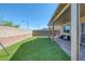 Green backyard featuring artificial grass, a covered patio, and brick privacy walls at 7720 Houston Peak St, Las Vegas, NV 89166