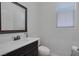Half bathroom with vanity and toilet at 7720 Houston Peak St, Las Vegas, NV 89166