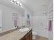 Bright bathroom featuring a granite-topped vanity, a large mirror, and a shower-tub combination at 7720 Houston Peak St, Las Vegas, NV 89166