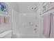 Clean bathroom with a shower-tub combination featuring white tile and pink decorative accents at 7720 Houston Peak St, Las Vegas, NV 89166