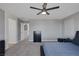 Spacious bedroom with a stylish platform bed, neutral tones, and ample closet space with grey walls at 7720 Houston Peak St, Las Vegas, NV 89166