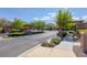 Scenic community entrance showcasing lush landscaping, stone accents, and tree-lined street at 7720 Houston Peak St, Las Vegas, NV 89166