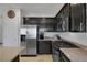 Close-up of kitchen featuring dark cabinets, granite countertops, and stainless steel appliances at 7720 Houston Peak St, Las Vegas, NV 89166