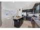 Bright, open kitchen with dark cabinetry, granite countertops, and stainless steel appliances at 7720 Houston Peak St, Las Vegas, NV 89166