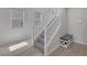 Carpeted staircase with white railings and natural light at 7720 Houston Peak St, Las Vegas, NV 89166