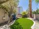 Private backyard featuring green artificial turf and landscaping at 7924 Mcdowell Dr, Las Vegas, NV 89129