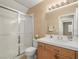 Well-lit bathroom with a shower featuring sliding glass doors and a white-tiled shower and vanity at 7924 Mcdowell Dr, Las Vegas, NV 89129