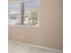 This bedroom features a window with white blinds and neutral-toned walls and carpet at 7924 Mcdowell Dr, Las Vegas, NV 89129