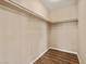 Walk-in closet with wooden floors and minimalist shelving at 7924 Mcdowell Dr, Las Vegas, NV 89129