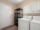 Functional laundry room with washer, dryer, and shelving for convenient storage at 7924 Mcdowell Dr, Las Vegas, NV 89129