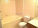 Simple bathroom with a neutral-colored tile surround on the tub at 8417 Running Deer Ave # 101, Las Vegas, NV 89145