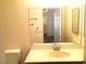 Bathroom featuring a large mirror, neutral walls, and a sink at 8417 Running Deer Ave # 101, Las Vegas, NV 89145