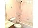 A well-lit bathroom with a tile shower, toilet, and wood-style cabinets at 8417 Running Deer Ave # 101, Las Vegas, NV 89145