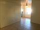 A spacious living room featuring tile floors, a ceiling fan, and neutral-colored walls at 8417 Running Deer Ave # 101, Las Vegas, NV 89145