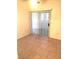 Well-lit living area boasts tile floors and sliding glass doors to outdoors at 8417 Running Deer Ave # 101, Las Vegas, NV 89145
