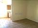 Spacious living room features tiled floors and flows into the kitchen at 8417 Running Deer Ave # 101, Las Vegas, NV 89145