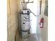 Utility room featuring an industrial water heater and convenient shelving at 8417 Running Deer Ave # 101, Las Vegas, NV 89145