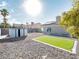 Backyard featuring gravel landscape, artifical grass and a storage shed with the house visible in the background at 849 Brahma Ln, Henderson, NV 89002
