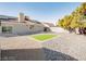 Backyard featuring gravel landscape, artifical grass and a storage shed with sliding glass doors to the house at 849 Brahma Ln, Henderson, NV 89002