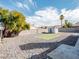 Fenced backyard with gravel landscape, artifical grass and a storage shed in a residential neighborhood at 849 Brahma Ln, Henderson, NV 89002