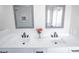 Bright bathroom vanity with double sinks, a white countertop, and black hardware at 849 Brahma Ln, Henderson, NV 89002