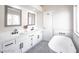 Bathroom featuring a new soaking tub, double sinks, and modern finishes at 849 Brahma Ln, Henderson, NV 89002