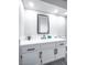 Bathroom vanity with white countertops and black fixtures, paired with modern shaker cabinets and large mirror at 849 Brahma Ln, Henderson, NV 89002